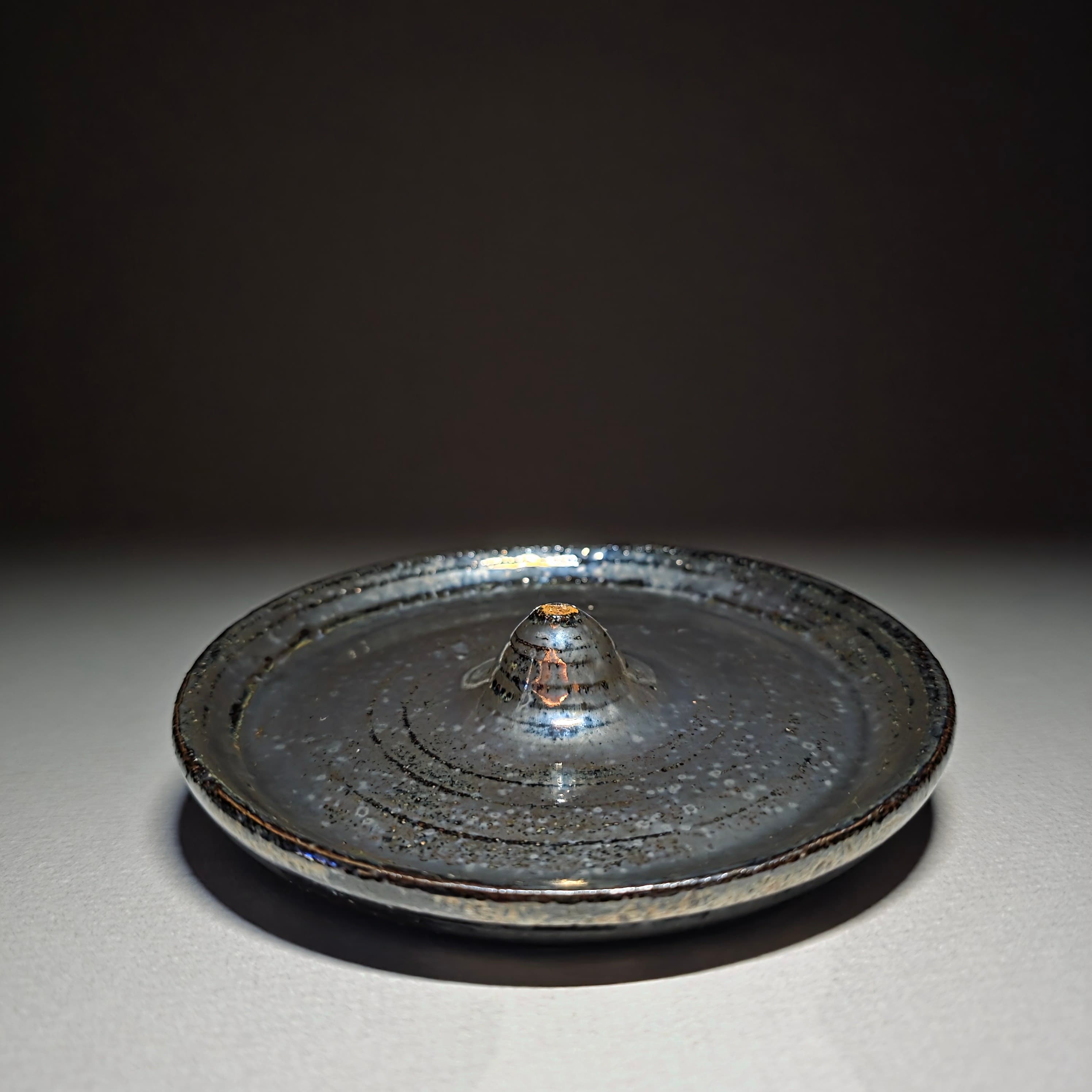 Chrome incense holder.